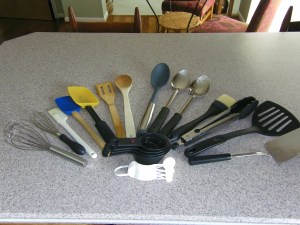 Whisks, spatulas, wooden spoons, variety of other spoons, basting brush, tongs, measuring cups and measuring spoons.