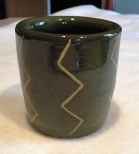 Again, I used a slip and then carved the "lightening" pattern, followed by a glaze.